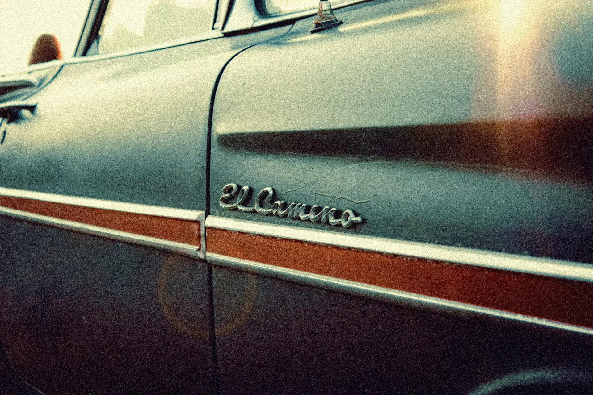 Sunlight on the chrome and painted body of a classic Chevrolet El Camino